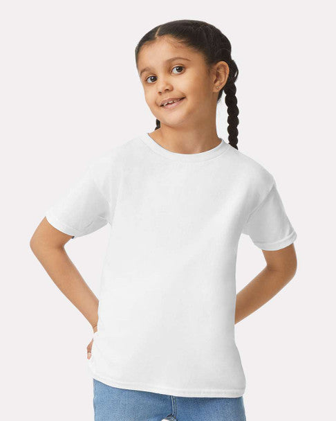 Young girl wearing a plain white t-shirt against a light gray background
